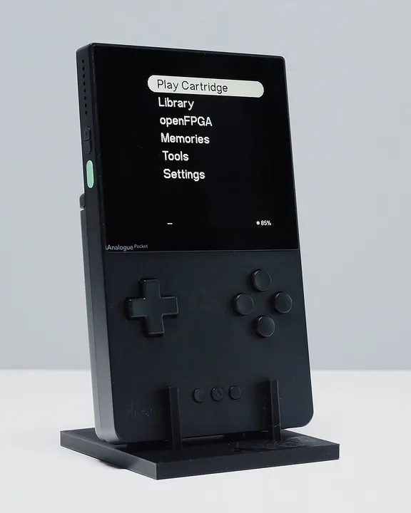 Black Analogue Pocket handheld standing in its dock