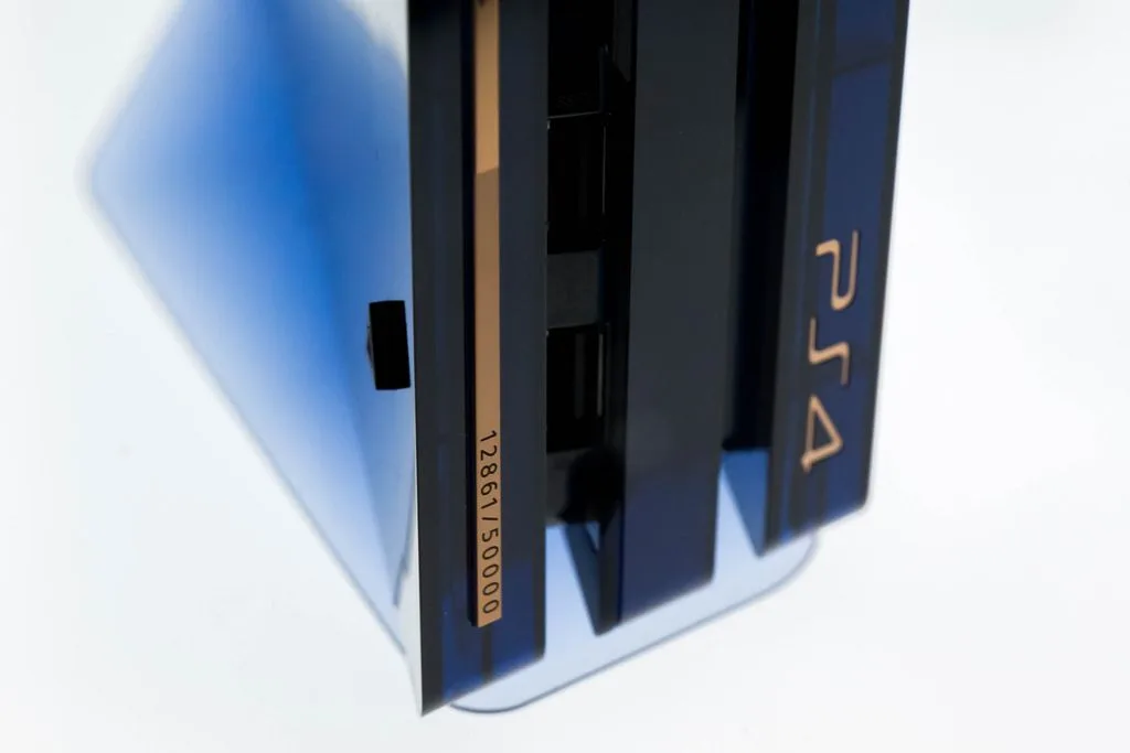 Close-up of the translucent blue PS4 Pro 500 Million Edition with copper number plate 12861/50000
