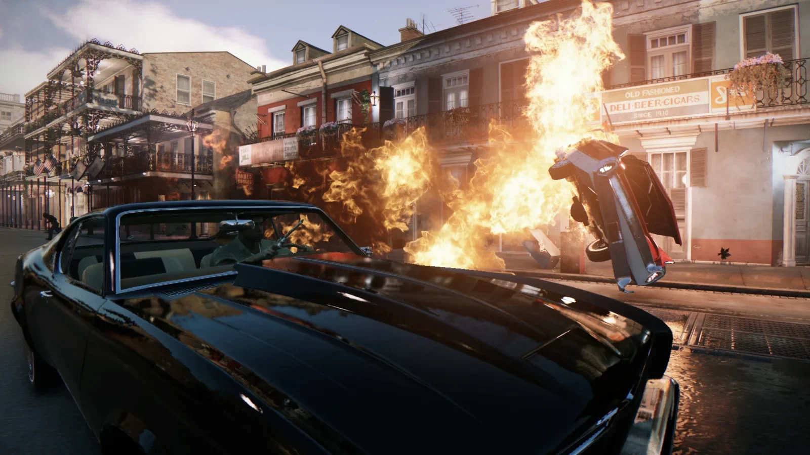 Official Mafia III: Definitive Edition screenshot of a car exploding on a New Bordeaux street