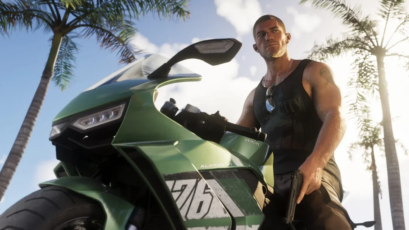 Jason Duval beside a green motorcycle.