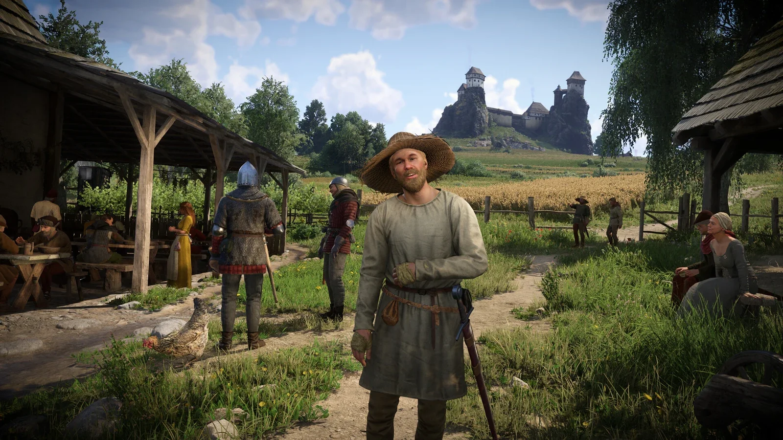 Henry and villagers standing outside timber houses in a sunny Bohemian village in Kingdom Come: Deliverance II