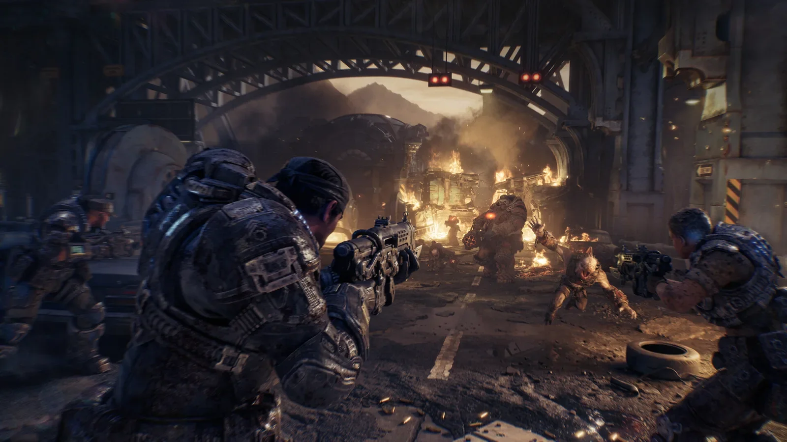Official Gears of War: E-Day screenshot of COG soldiers in a burning Kalona street during the Locust attack