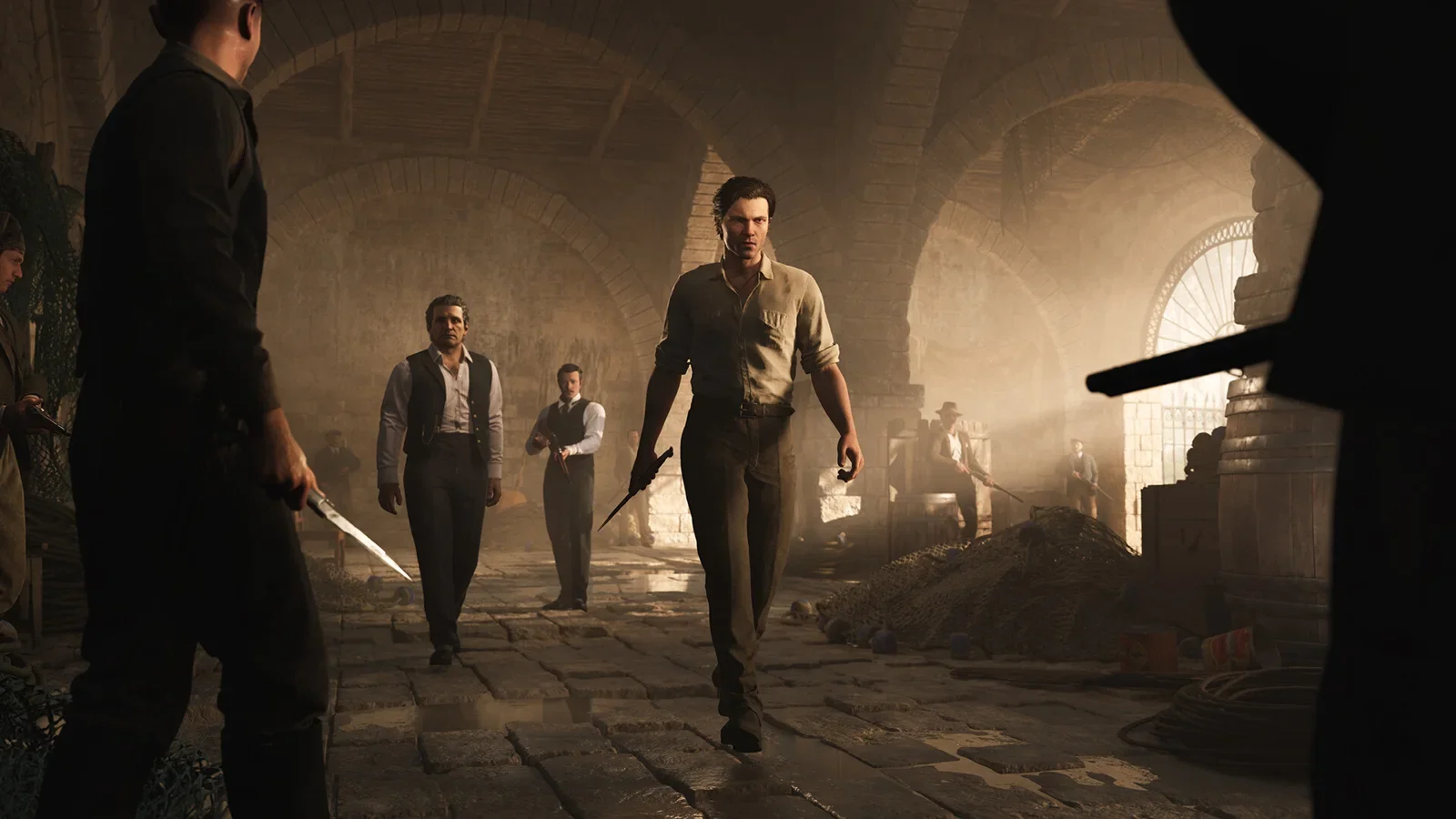 Official Mafia: The Old Country screenshot of Enzo walking with armed Torrisi men through a sunlit stone courtyard