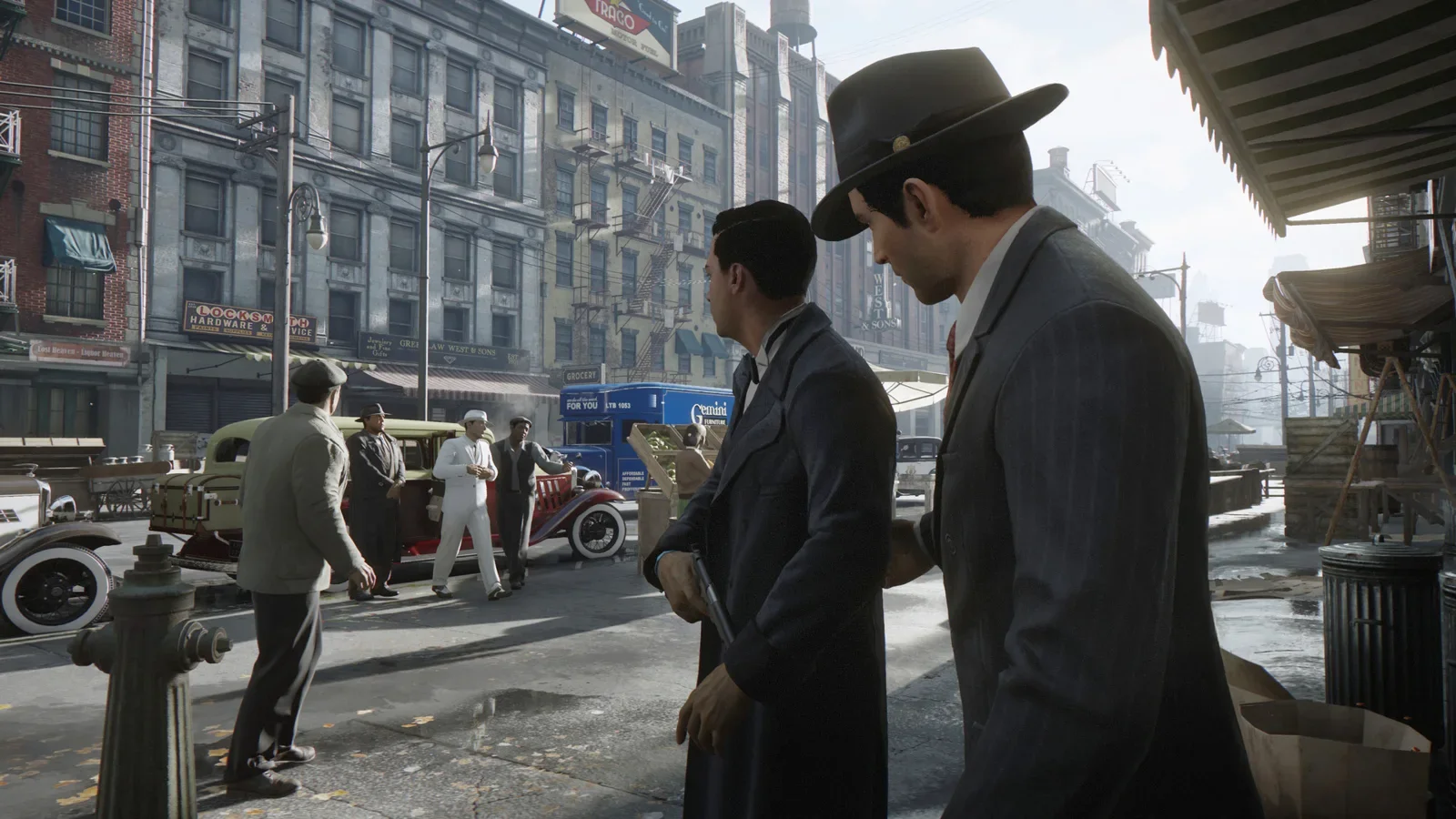 Official Mafia: Definitive Edition screenshot of Tommy Angelo and Sam on a Lost Heaven street