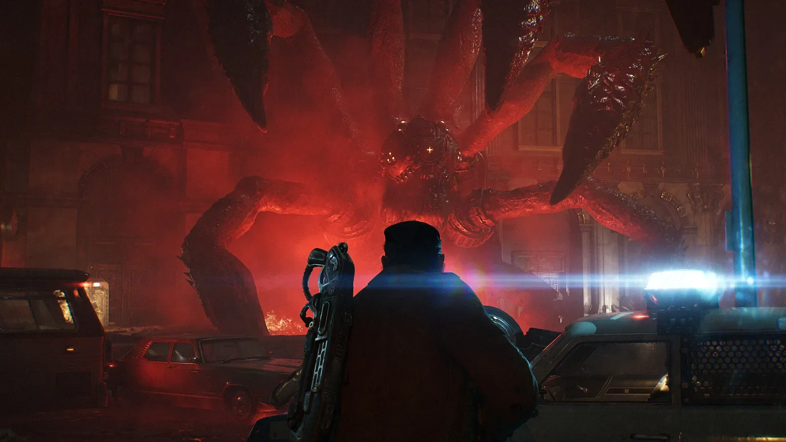 Official Gears of War: E-Day screenshot of a huge Locust creature lit in red looming over a soldier