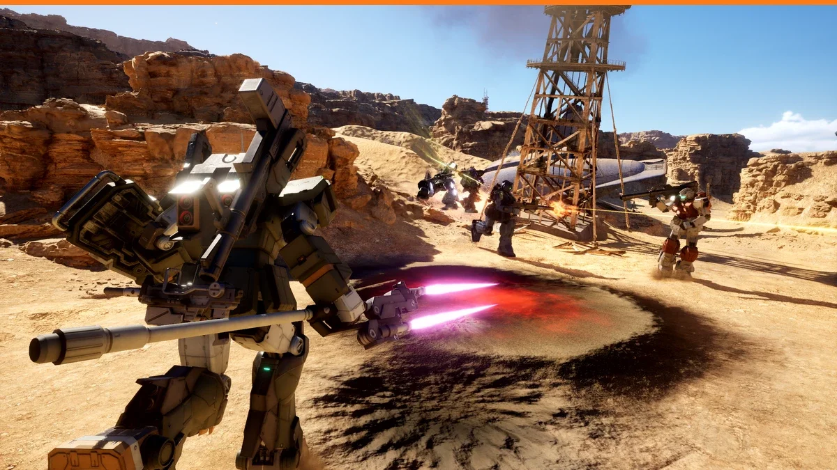 Grey-green Mobile Suit fires a beam weapon in a desert canyon beside an oil derrick while infantry and other mobile suits fight in the background