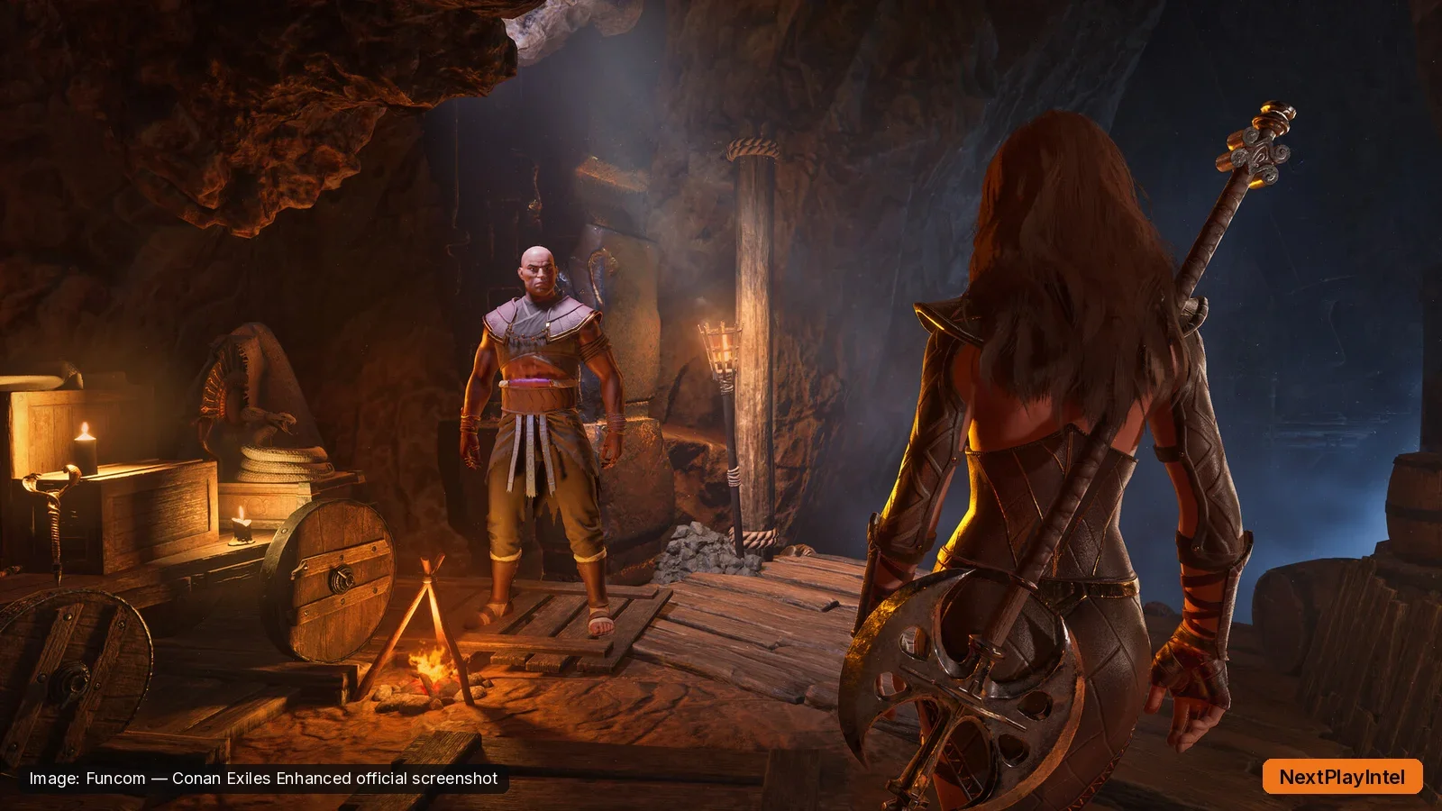 Conan Exiles Enhanced official screenshot of two characters in a torch-lit underground chamber